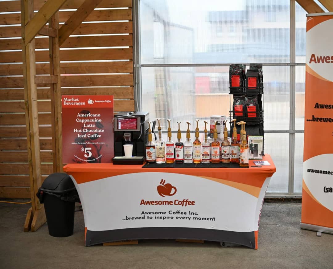 Awesome Coffee branded event booth with an espresso machine and syrup lineup